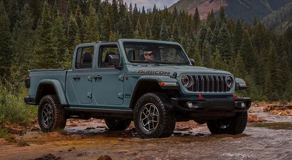Blue 2025 Jeep Gladiator Rubicon parked in a river