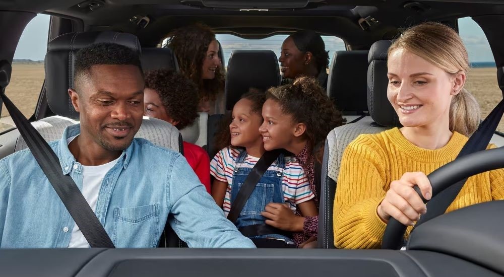 People are shown driving in a 2023 Land Rover Discovery.