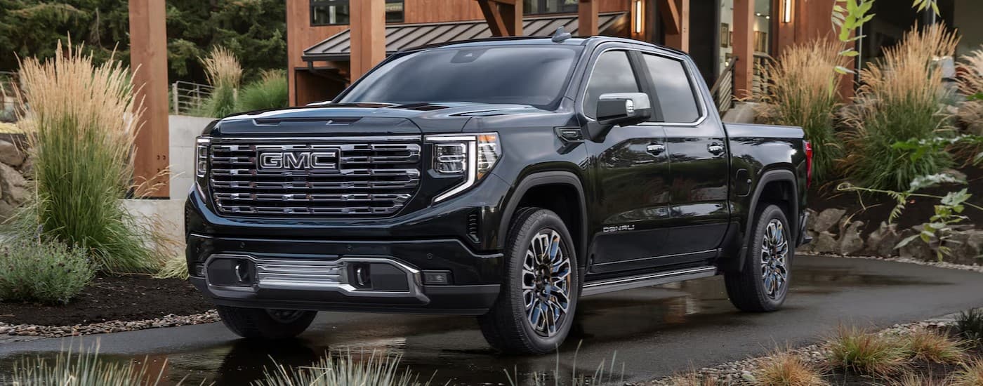 A black 2026 GMC Sierra 1500 Denali parked on a driveway.