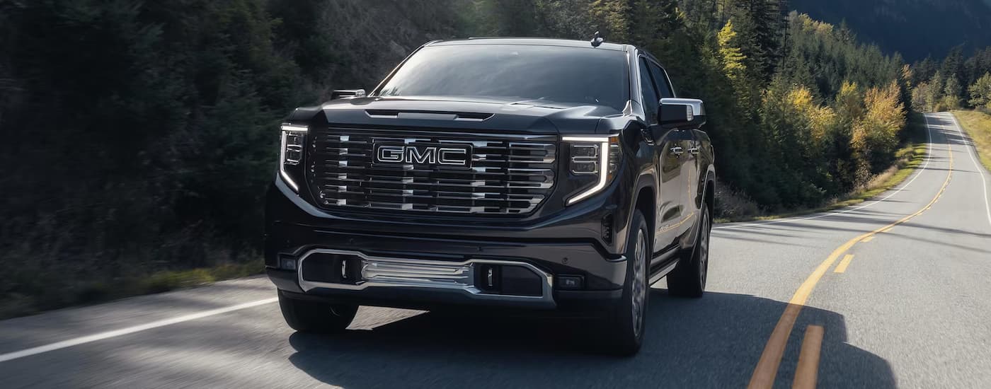 Black 2025 GMC Sierra 1500 Denali Ultimate driving on a highway