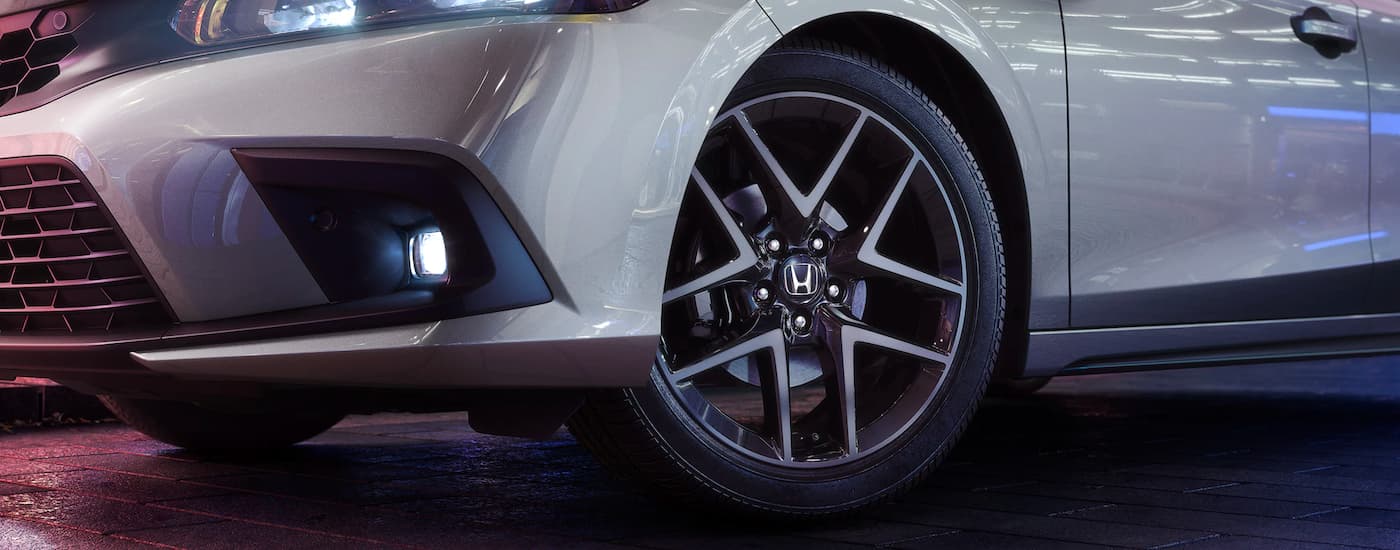 A close up shows the wheel on a silver 2023 Honda Civic Sport Touring.