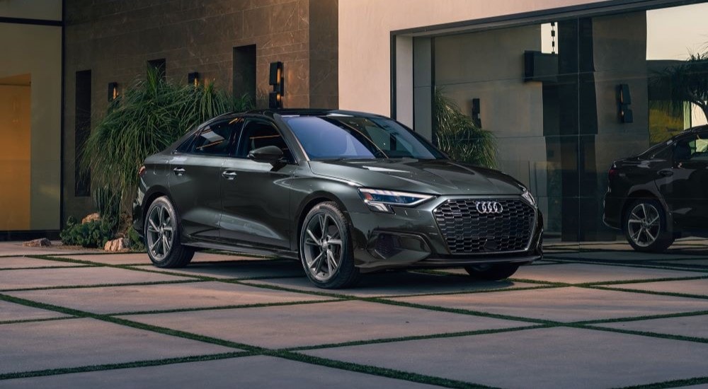 A grey 2024 Audi A3 is shown parked on a driveway after leaving a car dealership