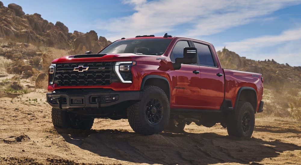 Red  2025 Chevy Silverado 2500HD ZR2 Bison off-roading on dirt