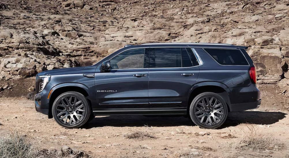 A blue 2025 GMC Yukon parked off-road.